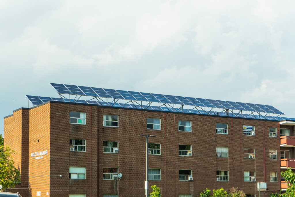 Multi-unit residential building with solar panels that underwent a deep retrofit.